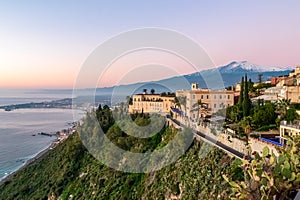 Luxury San Domenico Palace Hotel with panoramic view on snow capped Mount Etna volcano and Mediterranean sea in Taormina, Sicily