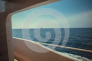 Luxury ship yacht window with a relaxing seascape ocean and blue sky view.