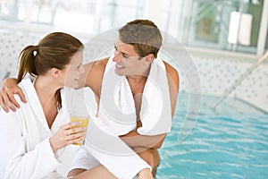 Luxury spa - happy couple relax at swimming pool