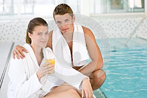 Luxury spa - young sportive couple relax at pool