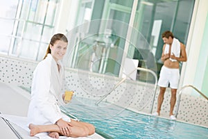 Luxury spa - young woman relax on poolside