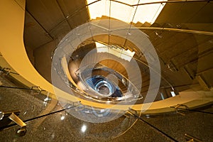 Luxury spiral staircase in lobby hotel with marble floor. Lighting architecture interior design decoration