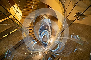 Luxury spiral staircase in lobby hotel with marble floor. Lighting architecture interior design decoration