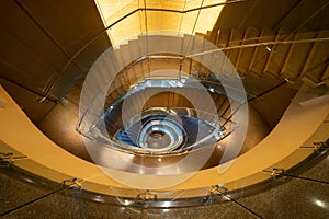 Luxury spiral staircase in lobby hotel with marble floor. Lighting architecture interior design decoration