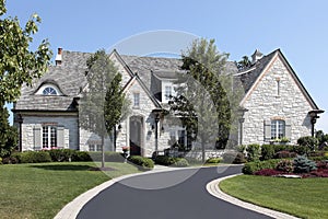 Luxury stone home with circular driveway photo