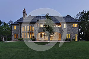 Luxury stone home at dusk