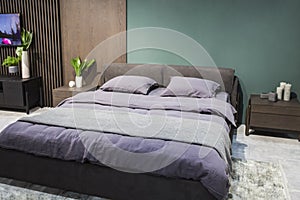 Luxury studio apartment in a loft style in dark colors. Stylish modern cozy bedroom area