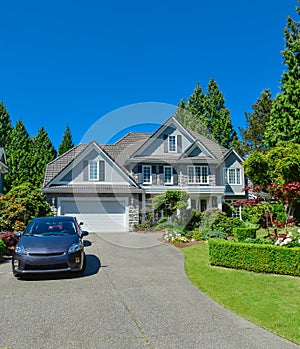 Luxury suburban house with double garage and car parked on concrete driveway