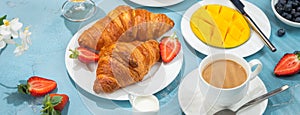 Luxury sunny continental breakfast on blue concrete background table with tropical plants shadows, banner