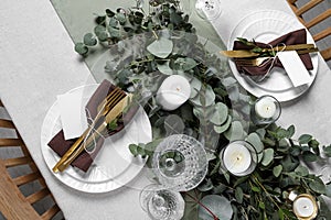 Luxury table setting with beautiful decor and blank cards. Festive dinner