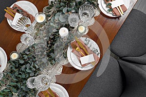 Luxury table setting with beautiful decor and blank cards, flat lay. Festive dinner