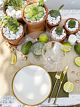 Luxury table setting with candles, succulents and tropical plants decoration