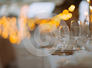 Luxury table settings for fine dining with and glassware, beautiful blurred background. Preparation for holiday