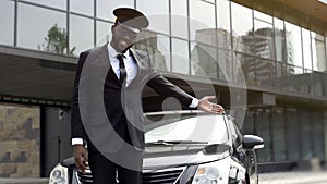 Luxury taxi service driver welcoming very important client near, expensive car