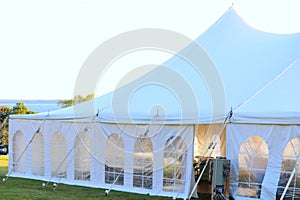 a luxury tent with ocean in background 