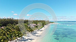 Luxury tropical beach in Mauritius. Beach with palms and blue ocean. Aerial view