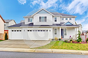 Luxury two level house exterior with garage and concrete driveway.