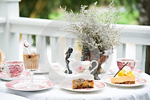 Luxury vintage coffee cup and tea, fruit cake,vintage milk jug, vintage flora on aged white table at balcony for breakfast