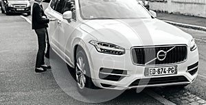 Luxury Volvo XC90 parked on French city with owner approaching