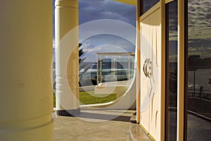 Luxury waterfront building entrance with door and pillar on sea