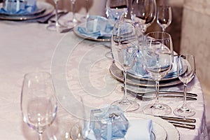 Luxury wedding arrangement of stylish glasses plates on napkins