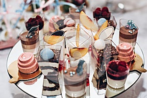 Luxury wedding catering, table with modern desserts, cupcakes, s