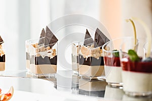 luxury wedding catering, table with modern desserts, cupcakes, sweets with fruit