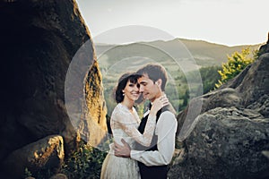 Luxury wedding couple is hugging each other in mountains