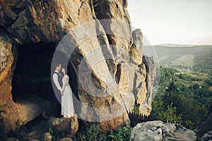 Luxury wedding couple is hugging each other in mountains