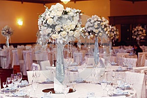 Luxury wedding decor with flowers and glass vases with jewels on