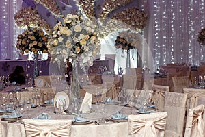 Luxury wedding decor with flowers and glass vases with jewels on