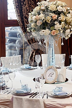 Luxury wedding decor with flowers and glass vases and number of