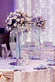 Luxury wedding decor with flowers and glass vases and number of