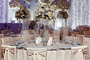 Luxury wedding decor with flowers and glass vases and number of