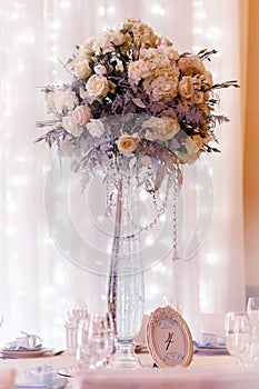 Luxury wedding decor with flowers and glass vases and number of