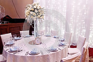 Luxury wedding decor with flowers and glass vases and number one