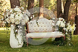 luxury wedding decorations with bench, candle and flowers compisition on ceremony place