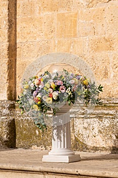 Luxury wedding floral decorations at the entrance of Ostuni church.