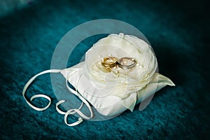 Luxury wedding golden rings on flower