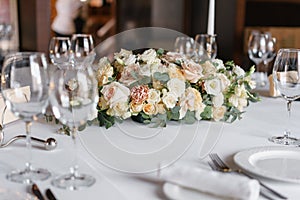 Luxury wedding reception. Flower arrangement on table in restaurant. Stylish decor and adorning.