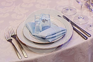 Luxury wedding reception. stylish glasses, plates on napkins and