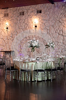 Luxury wedding table setting with flower centerpieces and candles