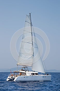 Luxury white catamaran boat in the ocean.