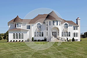 Luxury white home with front turret