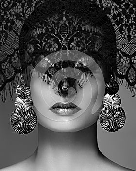 Luxury Woman with Celebrate Fashion Makeup, silver Earrings, Lace veil. Halloween or Christmas style. Black and white