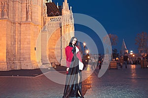 Luxury woman in evening dress at night city going to prom party Fashion and beauty of business lady. Girl with glamour