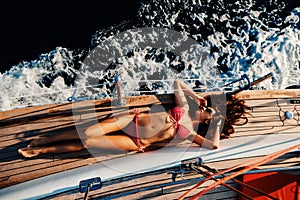 Luxury woman yachting in sea top view photo