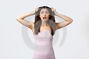 Luxury women, party and holidays concept. Troubled and anxious, panicking asian woman pull hair out of head alarmed