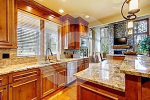 Luxury wood kitchen with granite countertop.