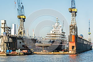 Luxury yacht being repaired at a dockyard in the harbor of Hamburg, Germany